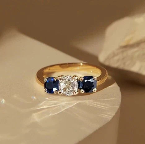 1+1 Offer: Golden Three Stone Cushion Cut White & Blue Sapphire Wedding Band Ring for Women + Round Cut White Sapphire Gold Necklace